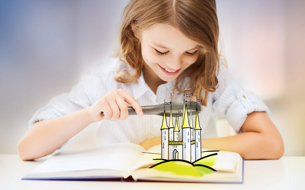 Girl with a magnifying glass looking at a book.