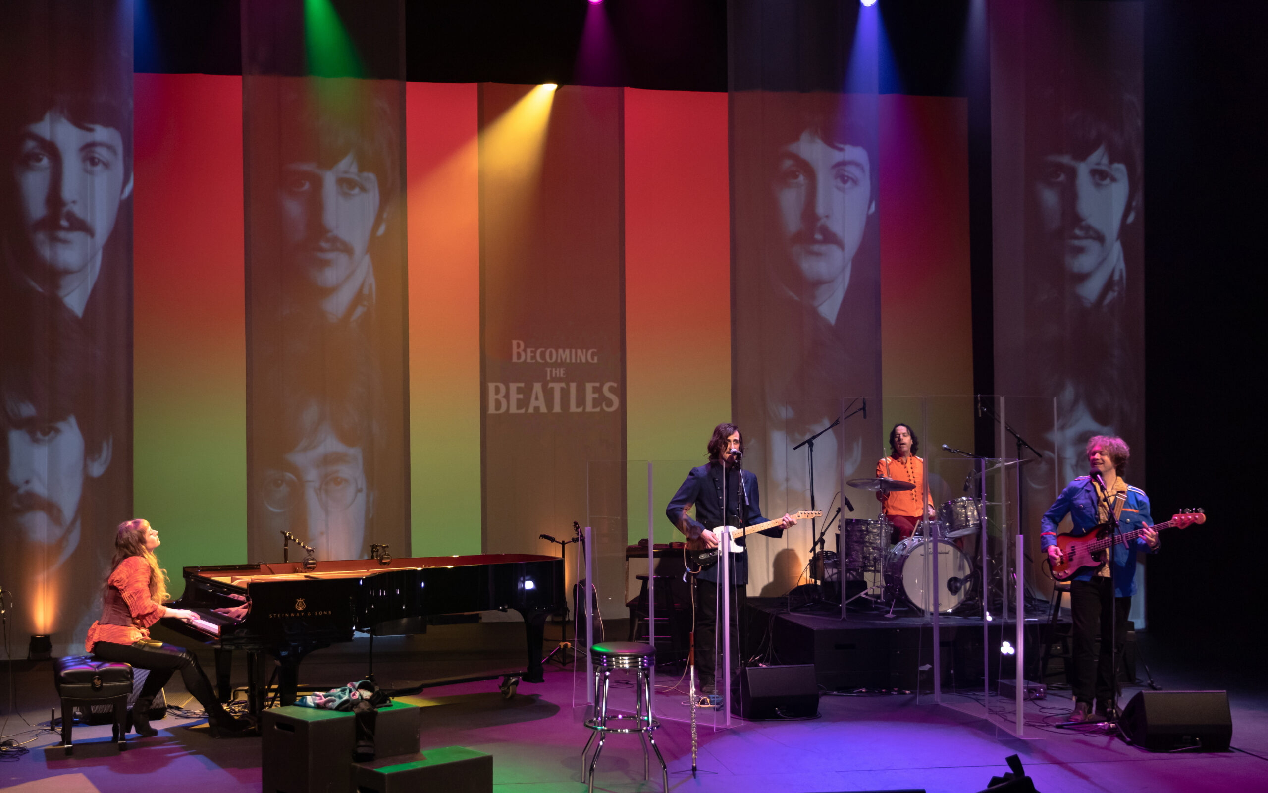 Becoming the Beatles promo with a live band on stage.