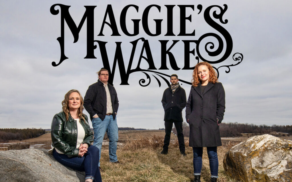 Maggie's Wake promo with four people standing on a mountain side.