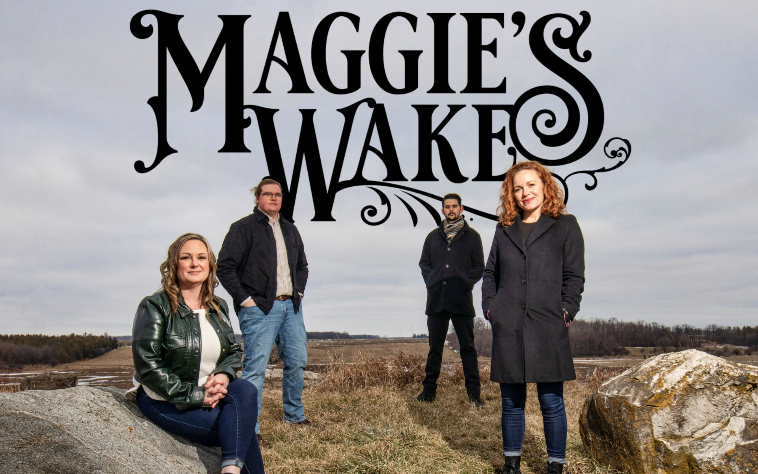 Maggie's Wake promo with four people standing on a mountain side.