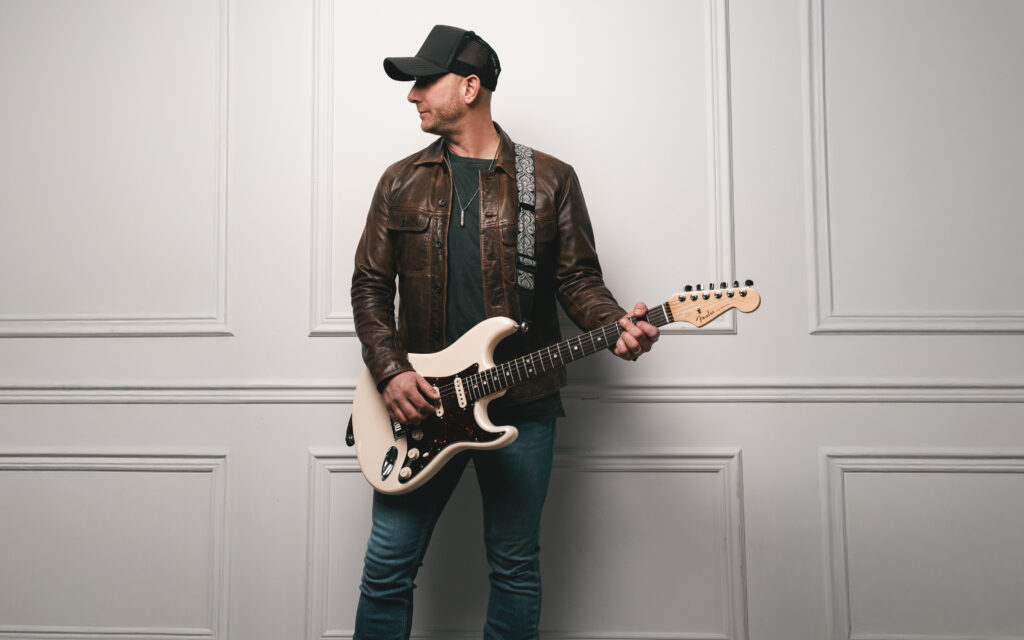 Tim Hicks playing a guitar.