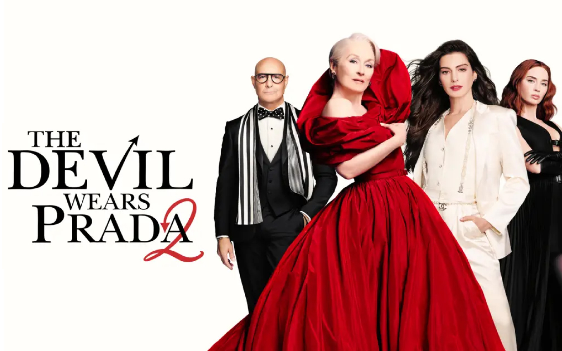 Photo of a women in a black dress, a women in a whit suit, a women in a red dress and man in a black suit.