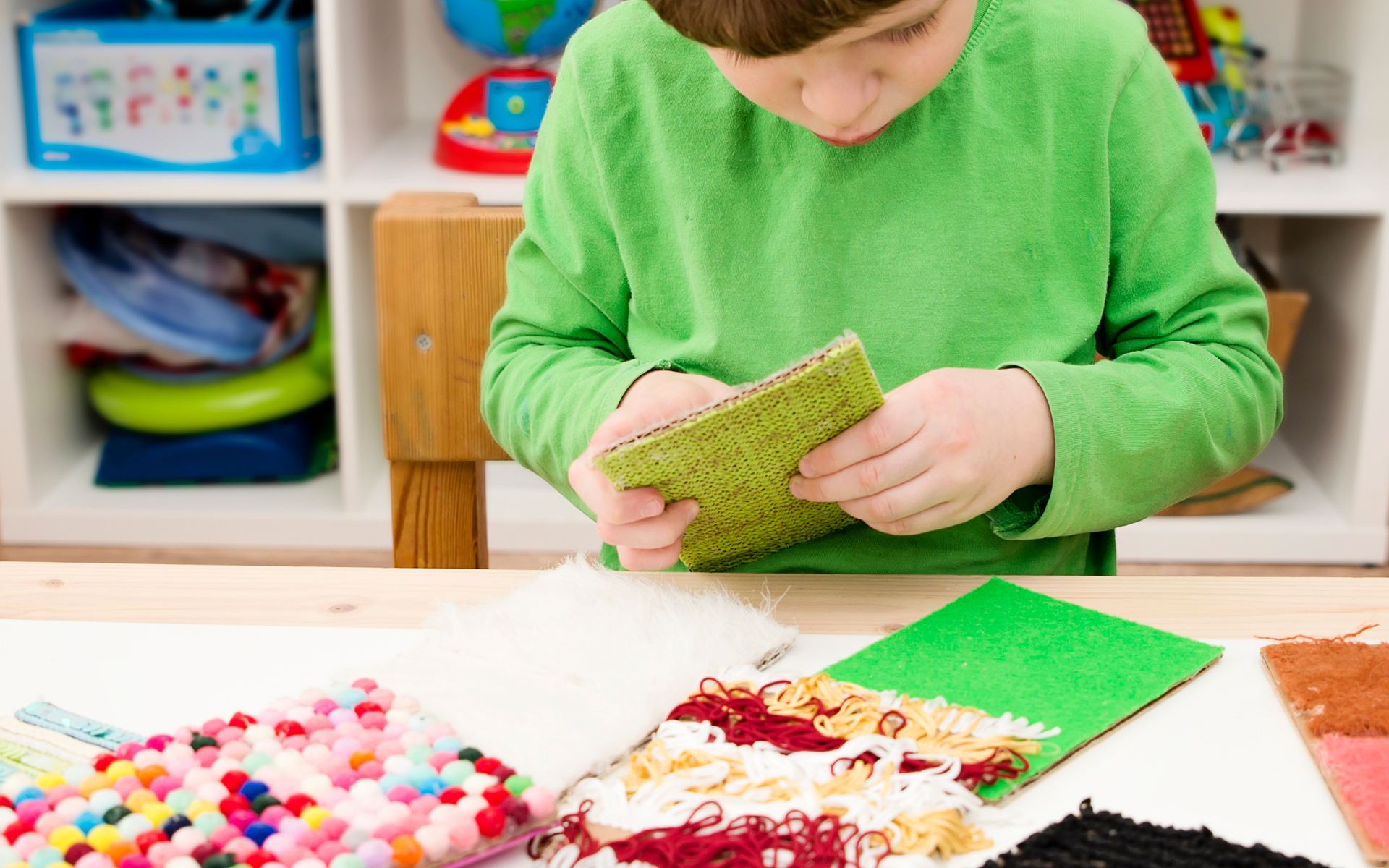Child doing crafts on a table.